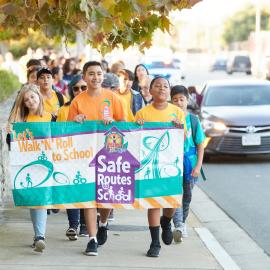 Schoolchildren walking to school during Walk to School Day Event